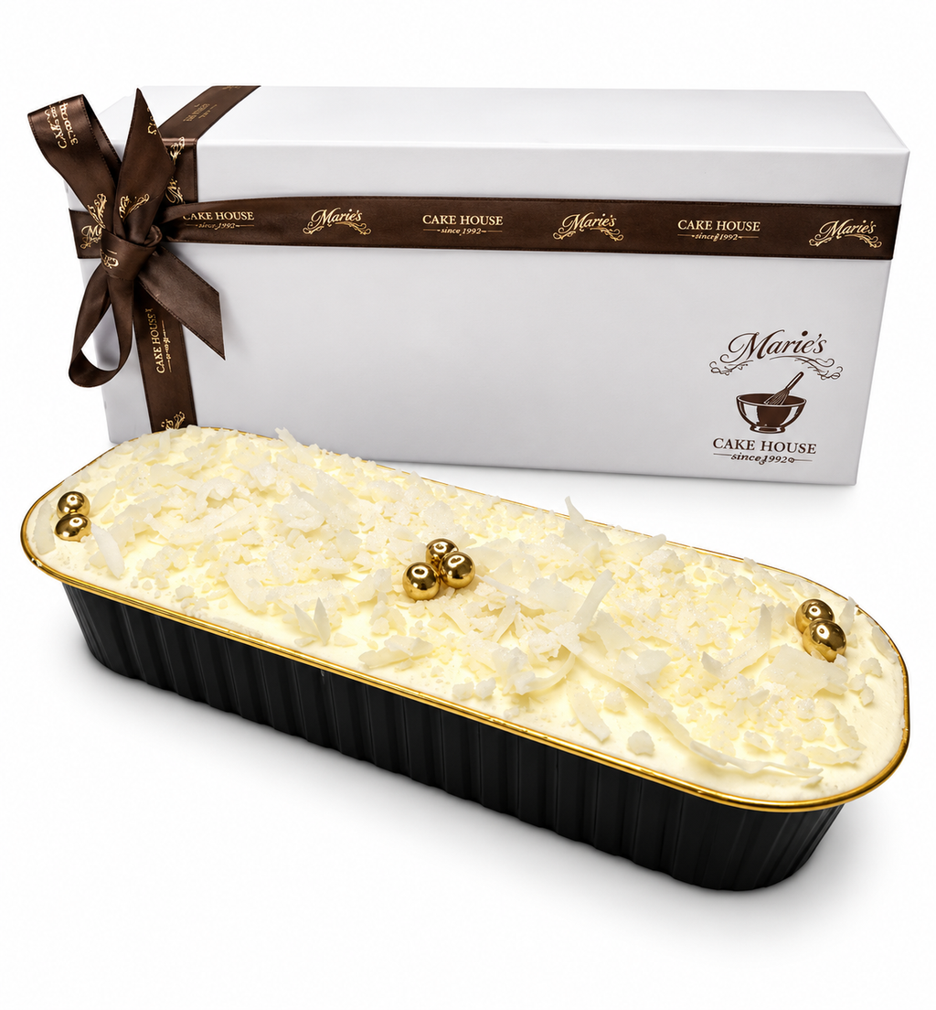 An elegant tray of Coconut sponge cake, covered in coconut buttercream, topped wth white coconut flakes, edible gold balls, white sugar crunch, and edible glitter. Perfect for corporate gifting, desk drops, product launches and hospitality gifting.