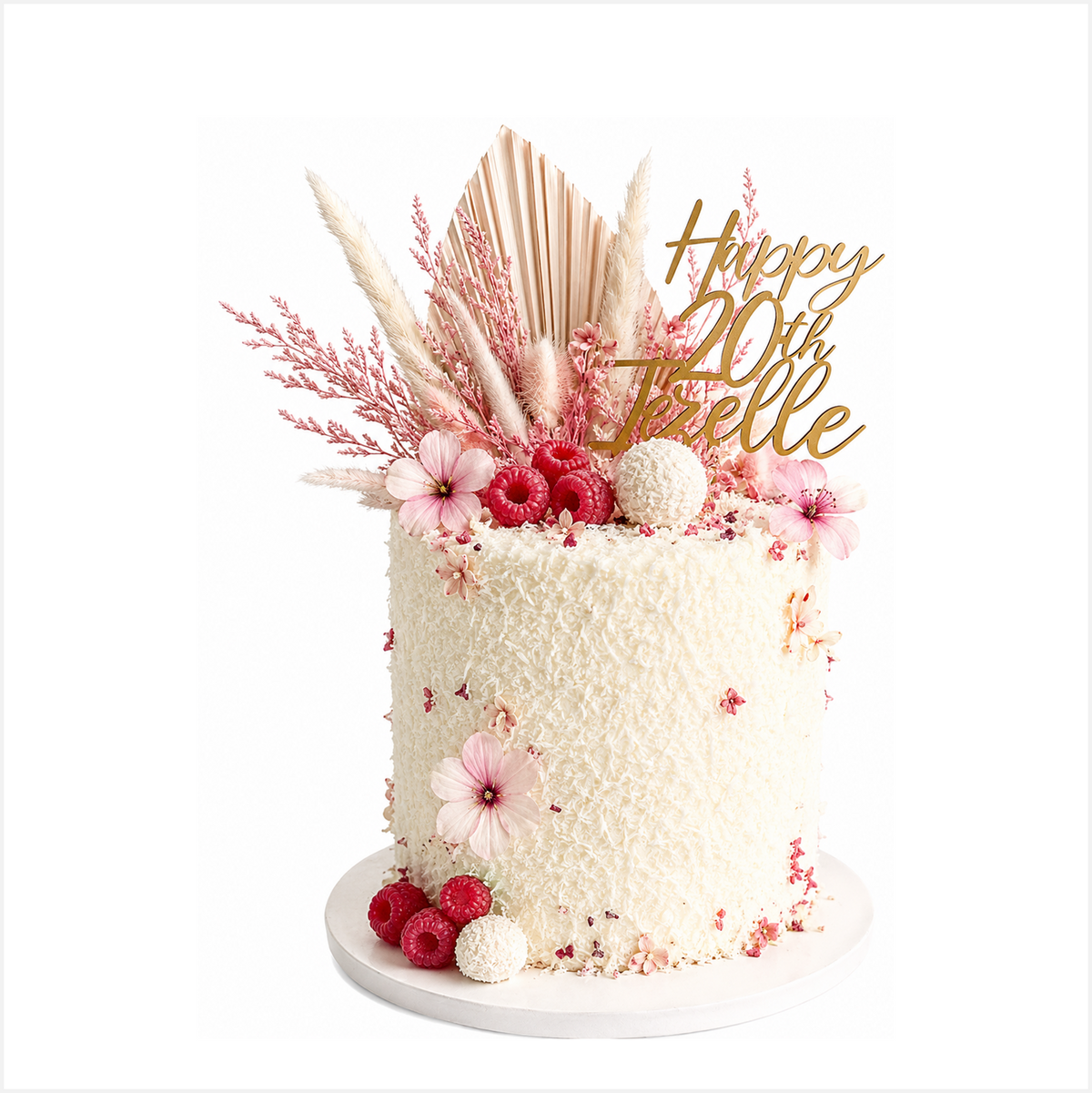 Coconut cake with raspberry jam filling, covered in coconut buttercream, decorated with desiccated coconut and freeze dried raspberries. Perfect for team celebrations and corporate and hospitality gifting