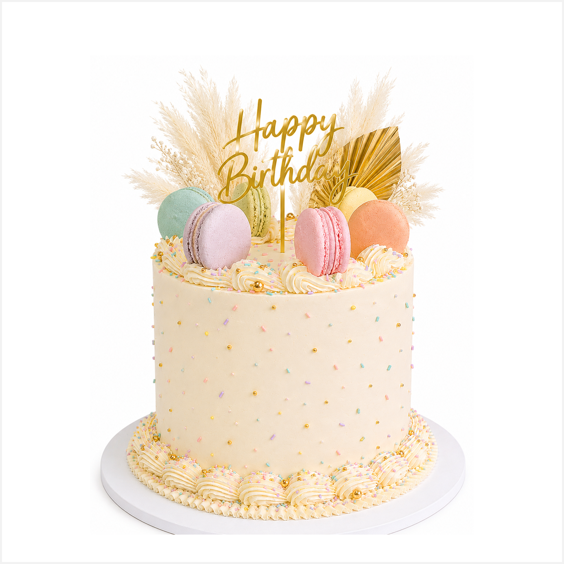 Vanilla buttercream cake with macarons and pampas decorations.